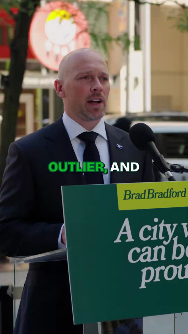 Still from Brad Bradford's 23 July 2026 announcement video, delivered at a podium bearing the slogan "A city we can be proud of."